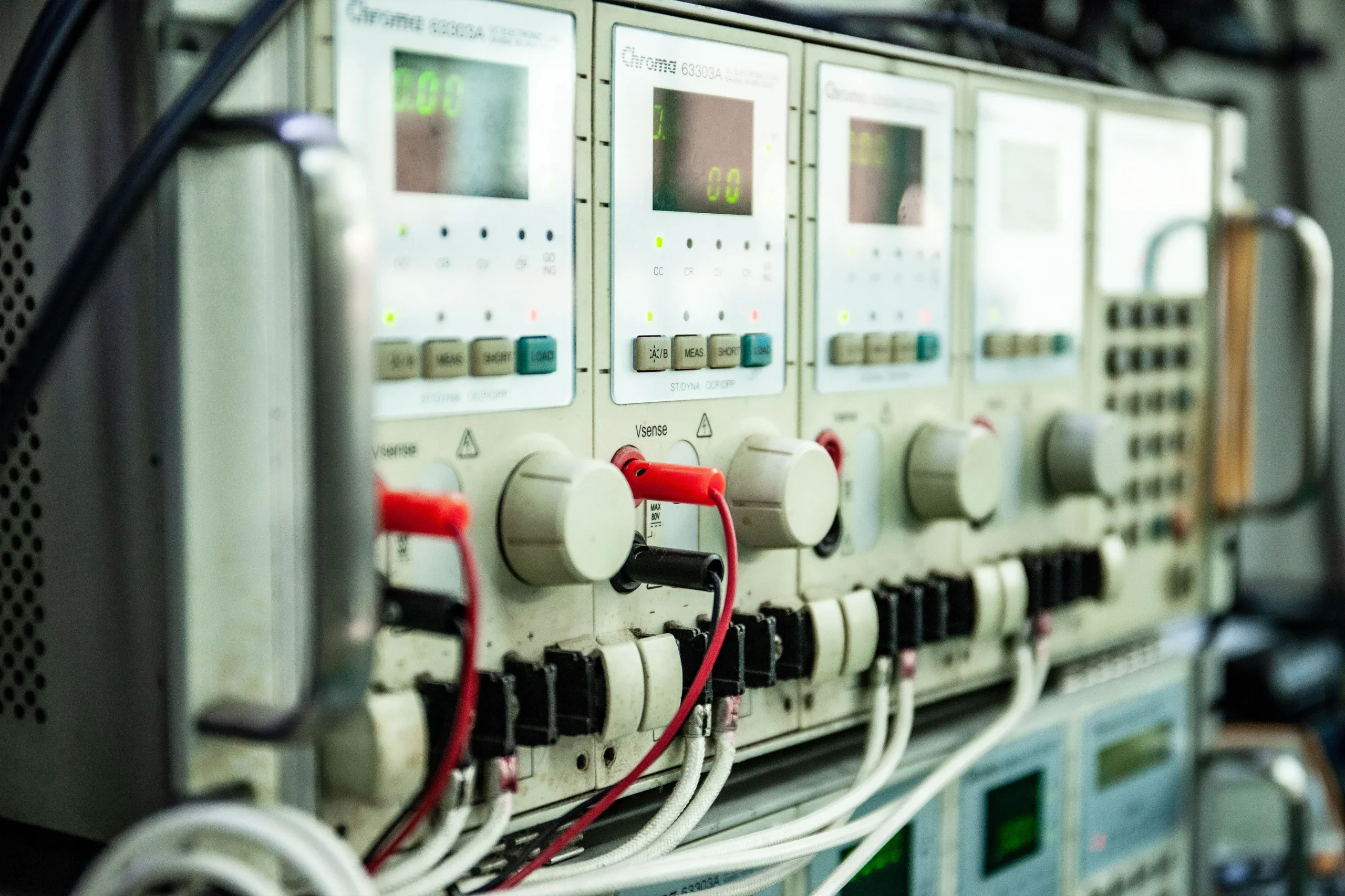 1STPLAYER factory PSU testing equipment — Chroma 63303A electronic load stations used for NGDP power supply certification testing